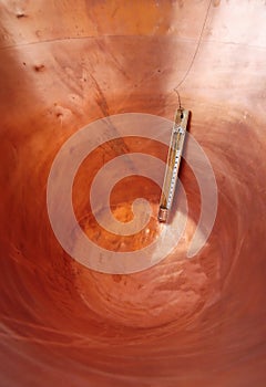 thermometer in a copper pot in the dairy