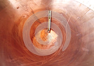 thermometer in a copper pot