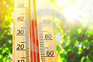 Thermometer displaying high 40 degree hot temperatures in sun summer day. photo