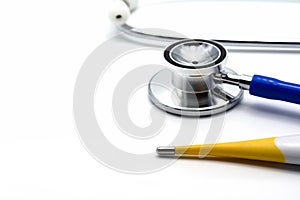 Thermometer with doctor stethoscope on white background, medical concept.