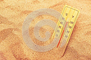 Thermometer on extremely warm desert sand