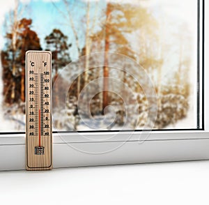 Thermometer on a frozen window and cold weather