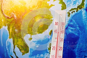 Thermometer with a high temperature of forty degrees Celsius, against the background of continent Southeast Asia, the Pacific