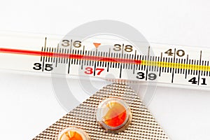 Thermometer with high temperature and orange pills