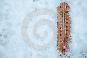 Thermometer lying on layer of ice and  showing low temperature