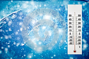 Thermometer or meteorological indicator in winter near the car shows low temperatures