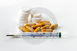 Thermometer and pills for healing gold or fever.