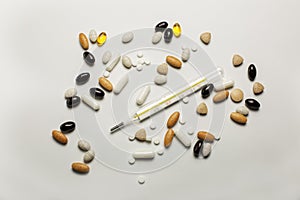 Thermometer, pills and vitamines isolated on a white background