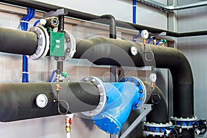 Thermometer, pipes and faucet valves of heating system in a boiler room