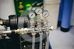 Thermometer, pipes and faucet valves of heating system in a boiler room