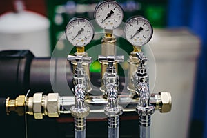 Thermometer, pipes and faucet valves of heating system in a boiler room