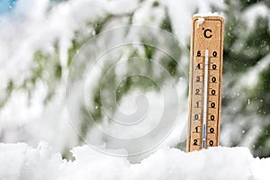 Thermometer showing freezing cold temperature in the snow