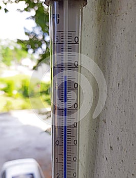 Thermometer showing very high temperature on a summer day