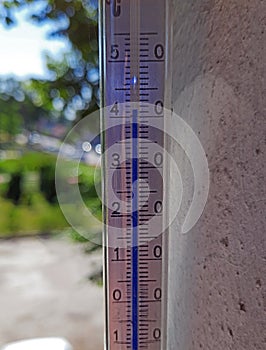 Thermometer showing very high temperature on a summer day