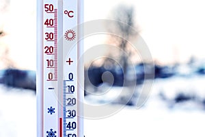 The thermometer shows 30 degrees of frost. Thermometer in the background of the winter landscape. Weather forecast. Very cold.