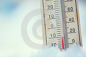 Thermometer on snow shows low temperatures under zero. Low tempe