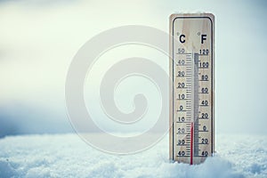 Thermometer on snow shows low temperatures under zero. Low tempe