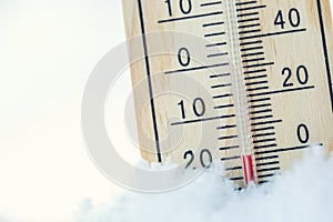 Thermometer on snow shows low temperatures under zero. Low tempe