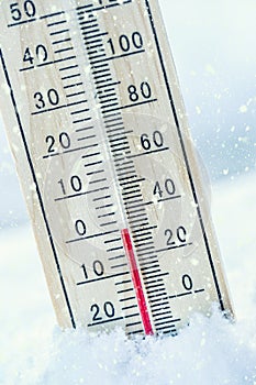 Thermometer on snow shows low temperatures zero. Low temperature