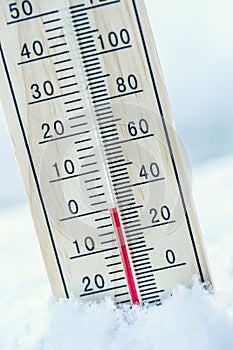 Thermometer on snow shows low temperatures zero. Low temperature photo