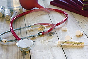 Thermometer , stethoscope and red books