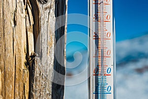 Thermometer strapped on a post outside in the mountain