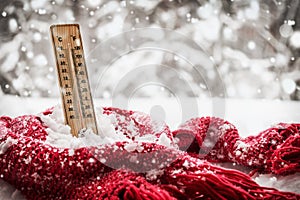 Thermometer with sub zero temperature sticks out in a snowdrift