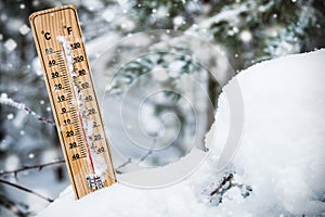 Thermometer with subzero temperature stuck in the snow