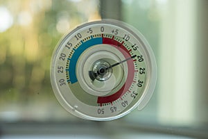 A thermometer of temperature outside the window that hangs on the window