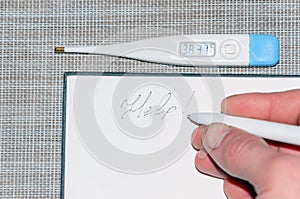 A thermometer with temperature readings and a note in the notebook for help