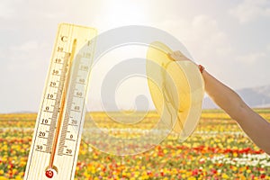 Thermometer in very hot day, high temperature or warm environment concept.
