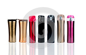 Thermos bottle isolated on white background. Coffee or tea reusable tumbler container. Thermos travel tumbler. Gold, red, pink,