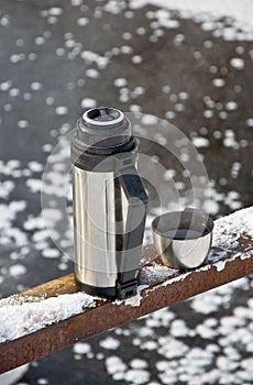 Thermos with hot tea photo