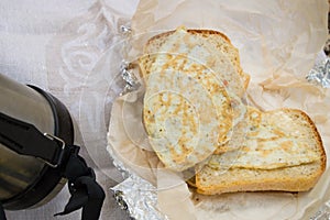 thermos of hot tea, coffee and wrapped in foil sandwiches for a picnic in the Park in autumn