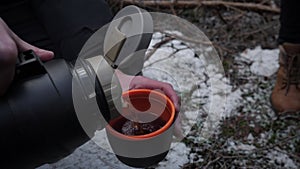 Thermos and hot tea on a winter hike