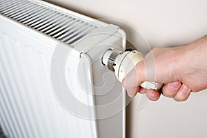 Thermostat adjustment by man's hand