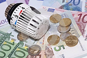 Thermostat with euro coins and banknotes.