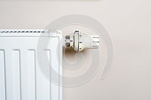 Thermostat and radiator on wall