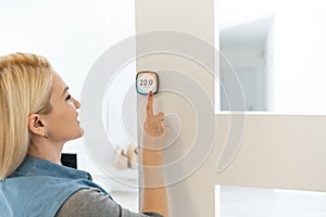 Thermostat smart home domotic control panel on wall for winter house temperature banner panoramic. Energy saving hand