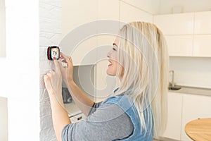 Thermostat smart home domotic control panel on wall for winter house temperature banner panoramic. Energy saving hand