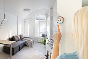 Thermostat smart home domotic control panel on wall for winter house temperature banner panoramic. Energy saving hand