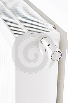 Thermostat turned off to save energy. White radiator in an apartment.