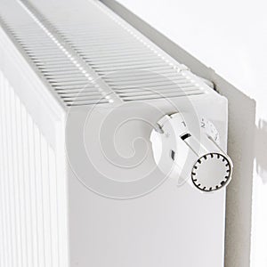 Thermostat turned off to save energy. White radiator in an apartment.