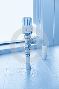 thermostat valve on white radiator close up photo
