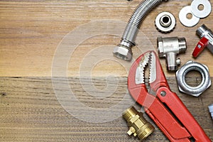 Thermostatic valve and plumber tools on wooden background