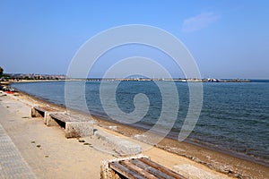 Thessaloniki, Greece - August 22 2019: Tables and chairs under wooden umbrellas by the sea, Peraia and Neoi Epivates beach.