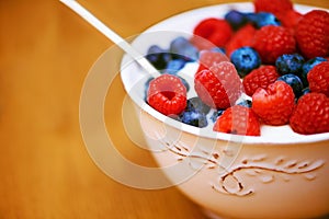 Theyre berry good for you. Closeup shot of a delicious bowl of berries in yoghurt.