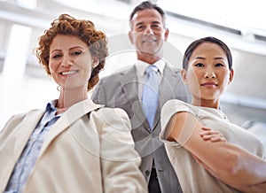 Theyre the best in the business. Low angle portrait of a group of businesspeople standing together in an office setting.