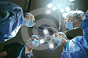 Theyre the best in their field. Low angle shot of surgeons in an operating room.