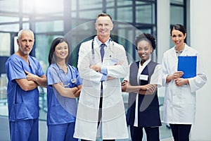 Theyre a dedicated team of healthcare professionals. Portrait of a group of smiling medical professionals standing in a